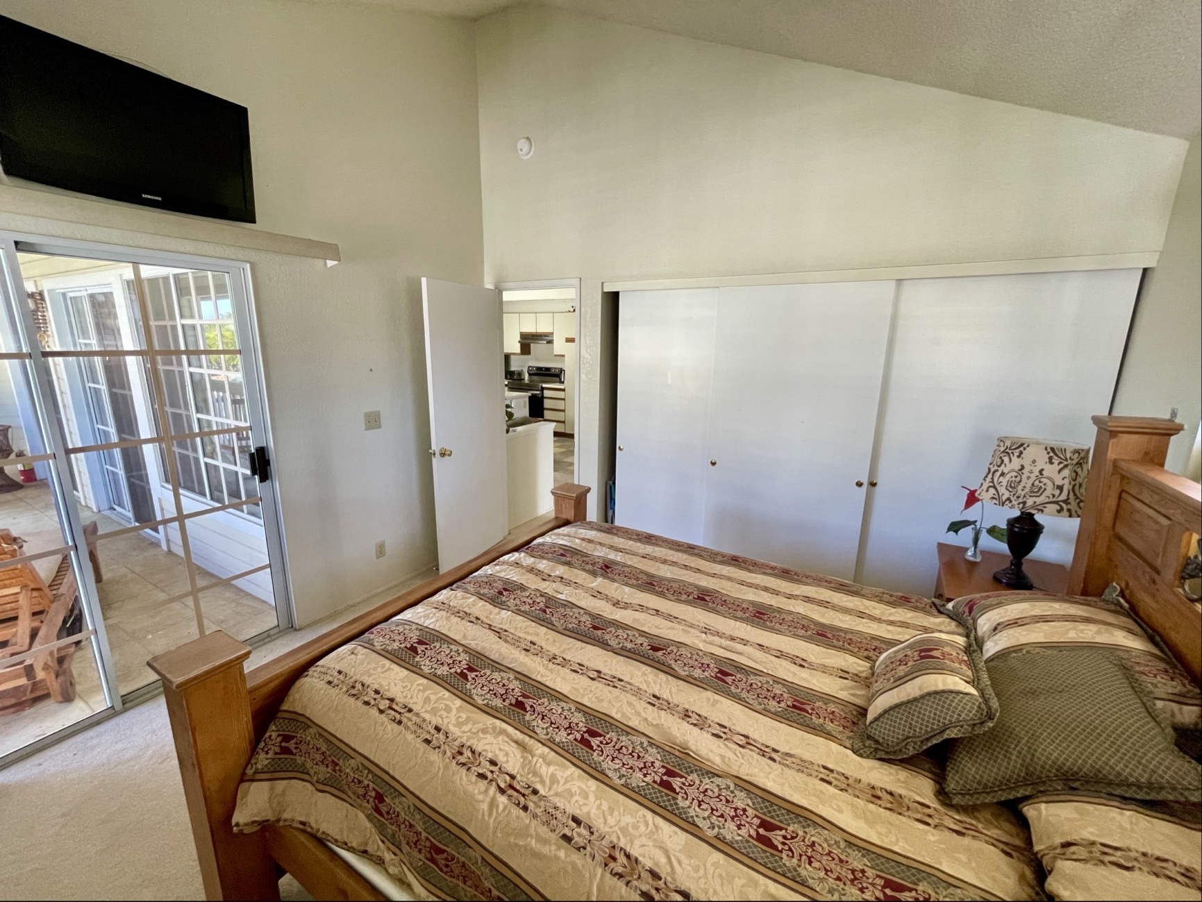 68-3883 Lua Kula Street, Unit 2005 Waikoloa, HI 96738 - Photo 20 of 28 a bedroom with a bed and wooden floor