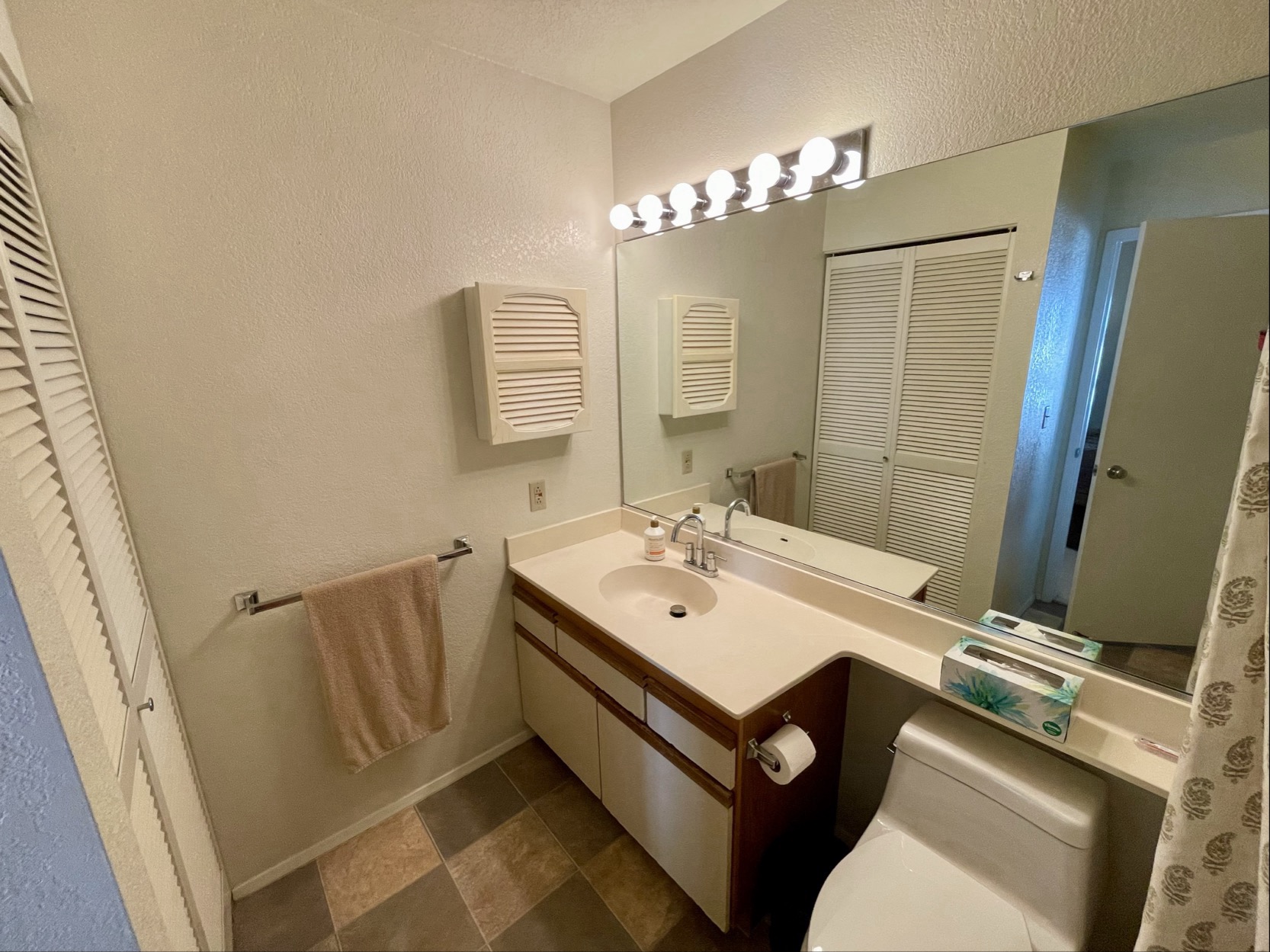 68-3883 Lua Kula Street, Unit 2005 Waikoloa, HI 96738 - Photo 26 of 28 a bathroom with a sink a toilet and mirror