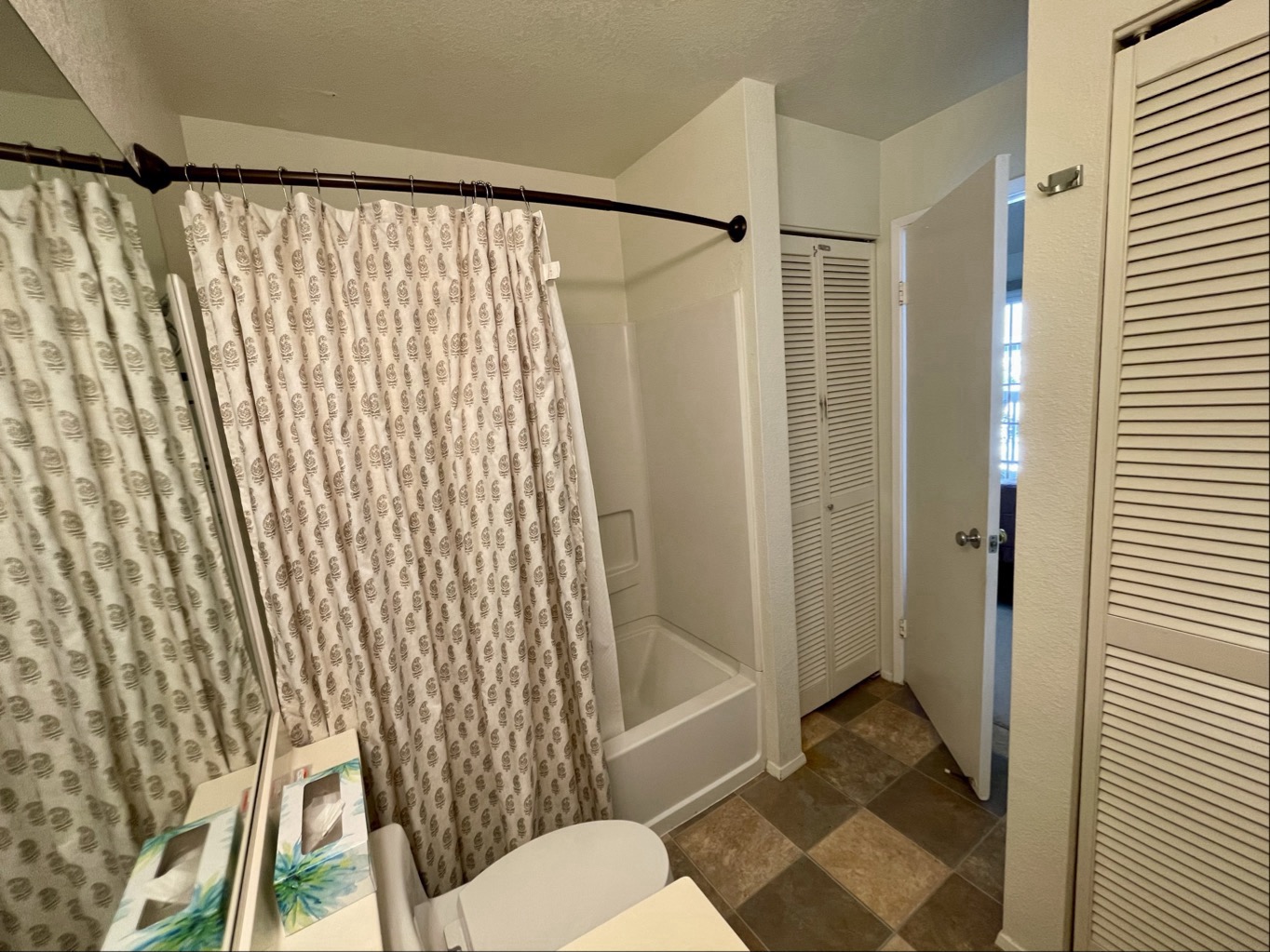 68-3883 Lua Kula Street, Unit 2005 Waikoloa, HI 96738 - Photo 27 of 28 a bathroom with a shower curtain and a toilet