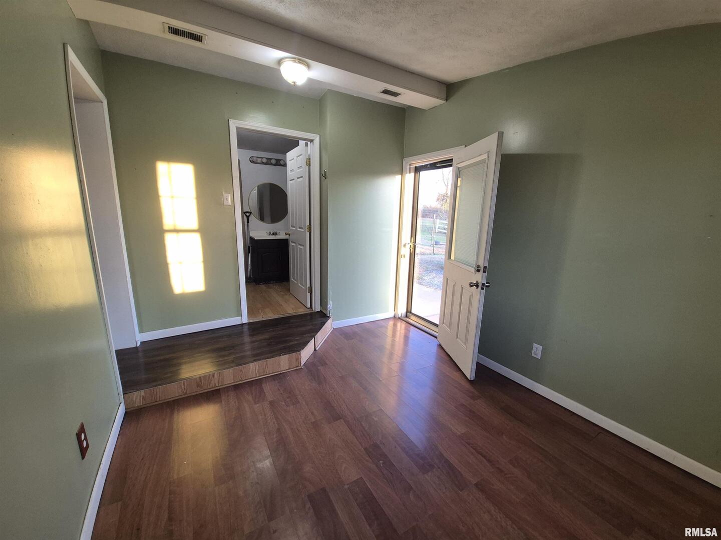 1100 Moore Street Eldorado, IL 62930 - Photo 10 of 20 a view of a hallway with wooden floor and windows