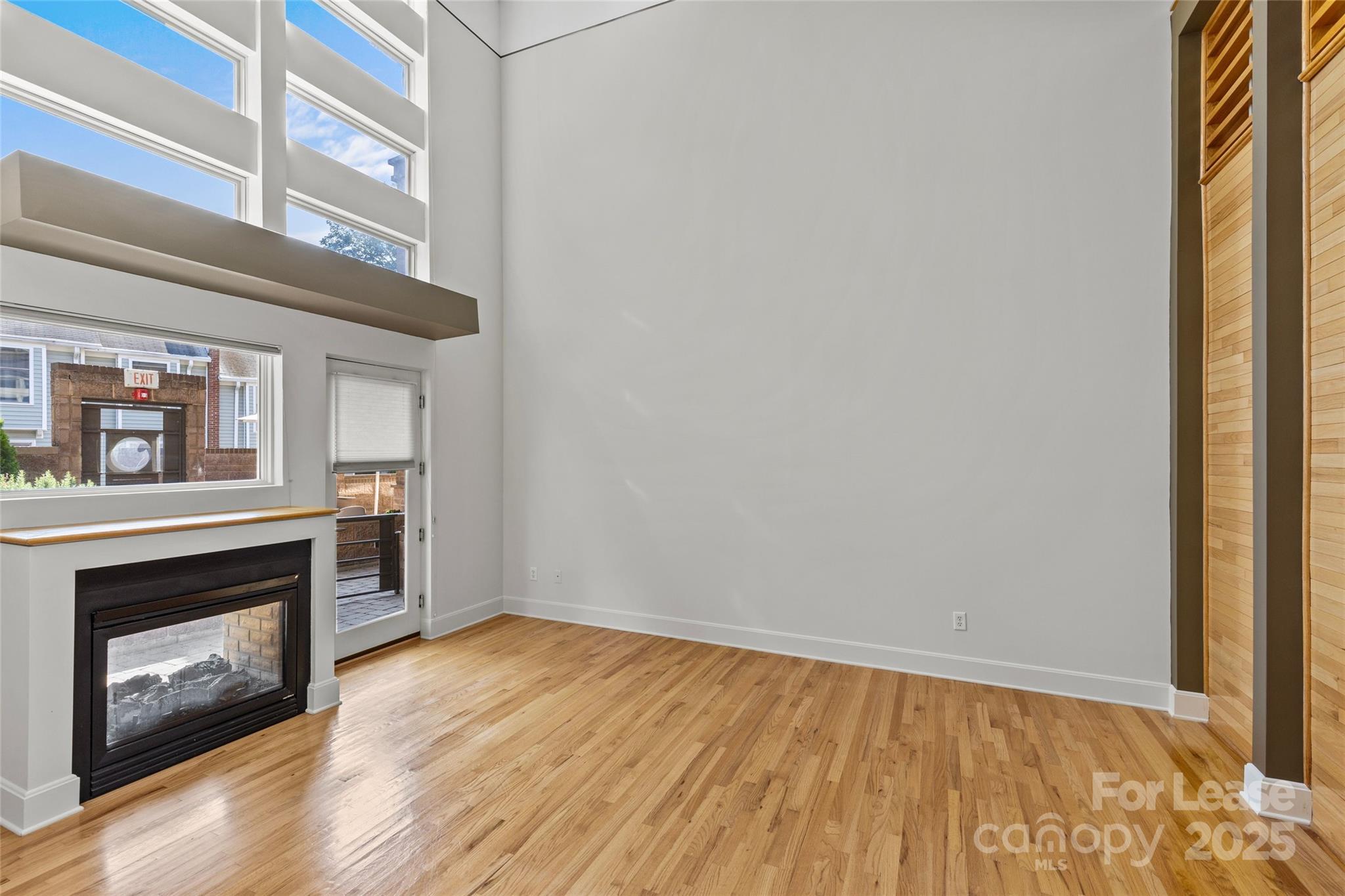 420 Queens Road, Unit 7 Charlotte, NC 28207 - Photo 13 of 46 a view of an empty room with wooden floor and a window