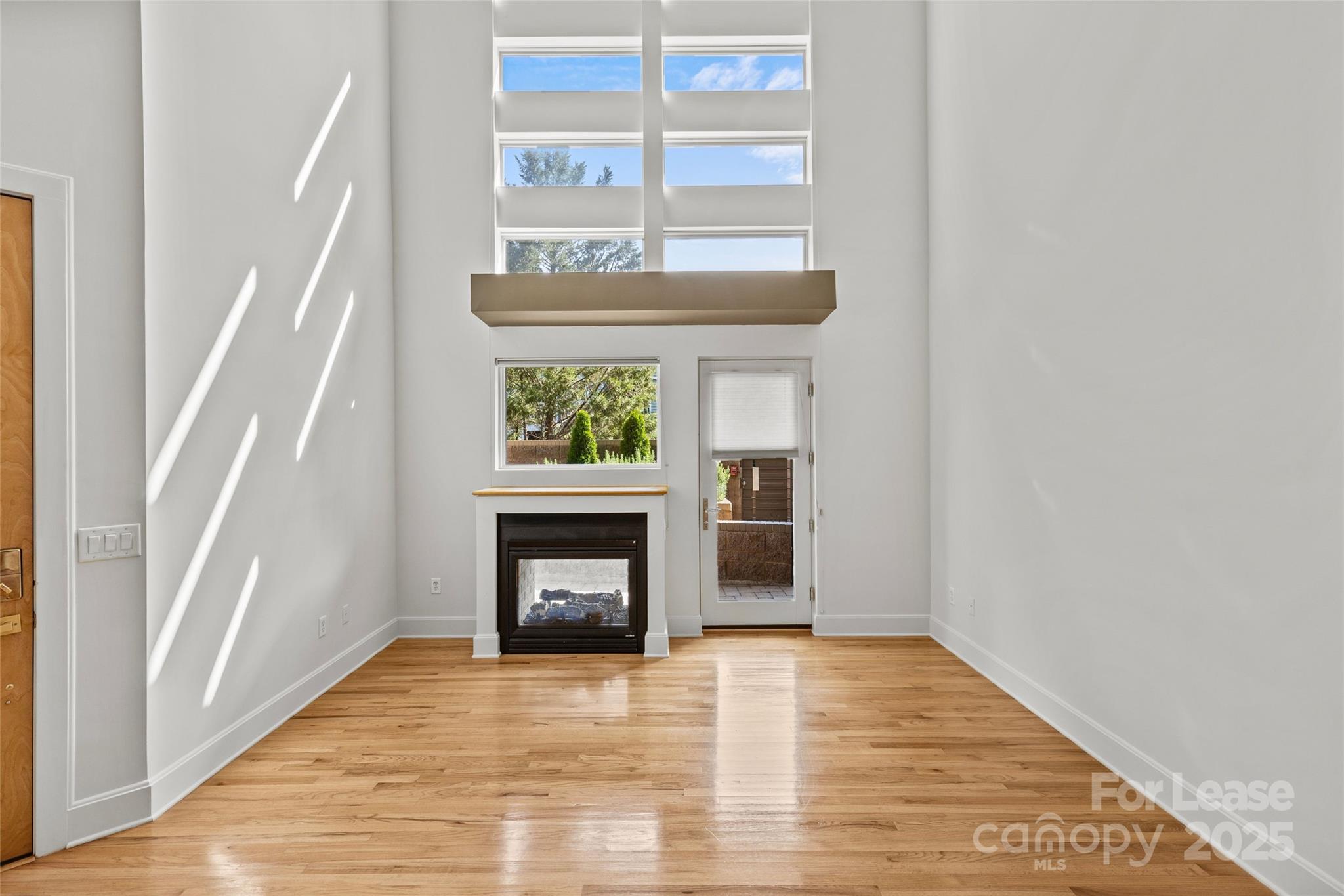 420 Queens Road, Unit 7 Charlotte, NC 28207 - Photo 14 of 46 a view of an empty room with a window and fireplace