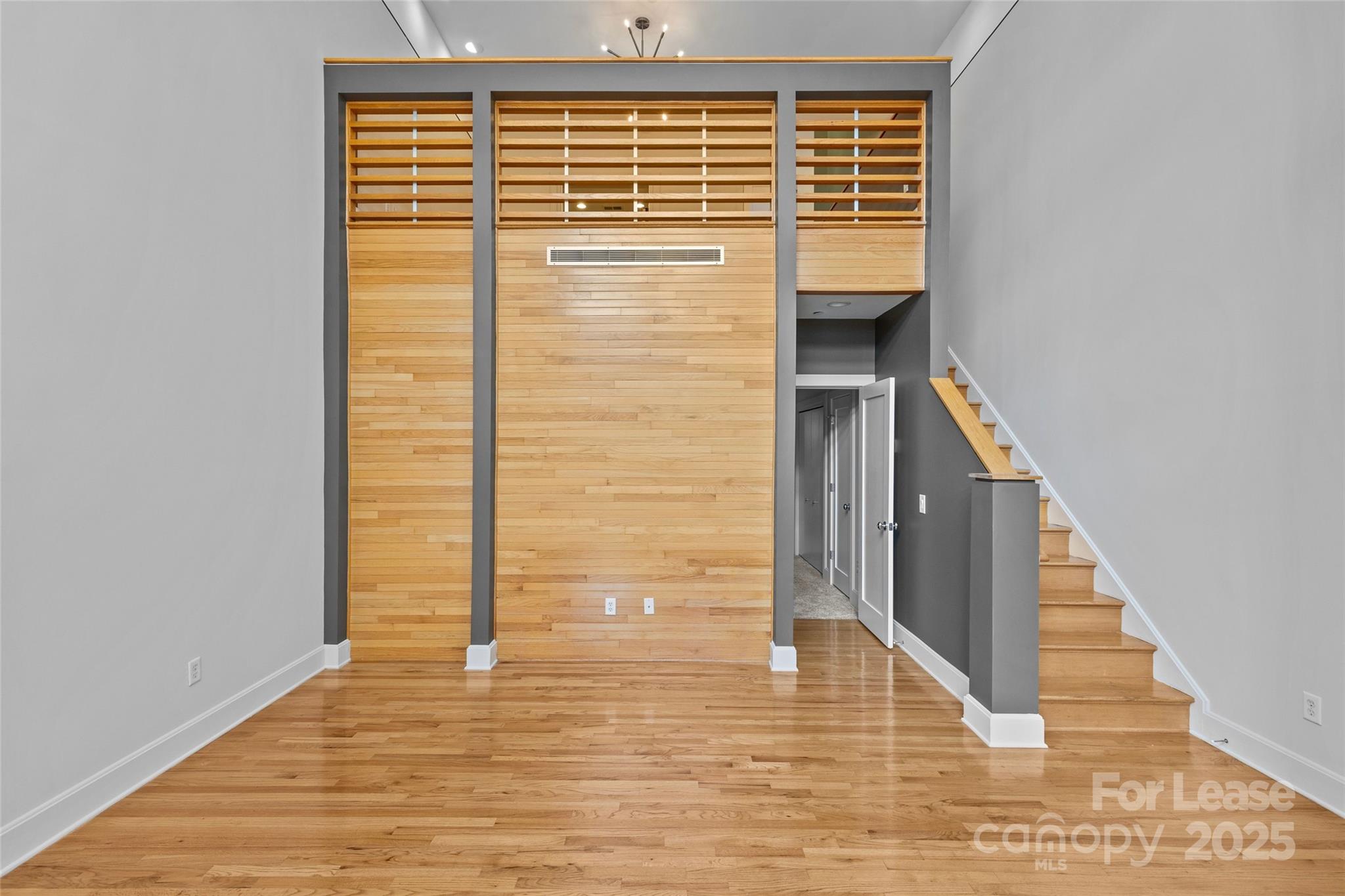 420 Queens Road, Unit 7 Charlotte, NC 28207 - Photo 16 of 46 a view of a hallway with wooden floor and staircase
