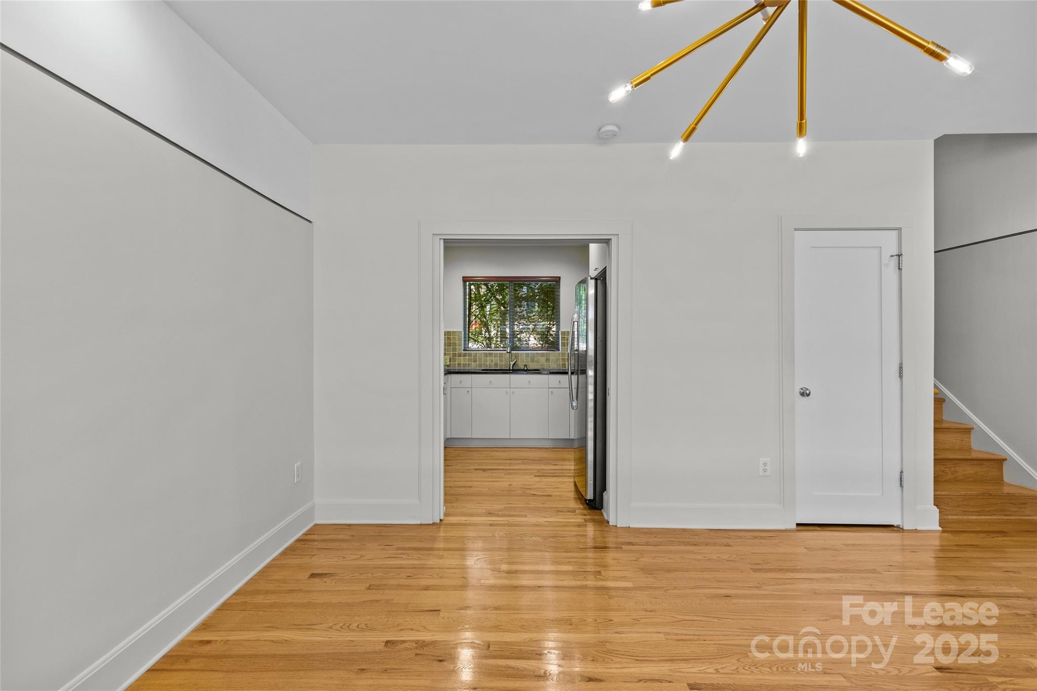 420 Queens Road, Unit 7 Charlotte, NC 28207 - Photo 31 of 46 a view of a big room with wooden floor and windows