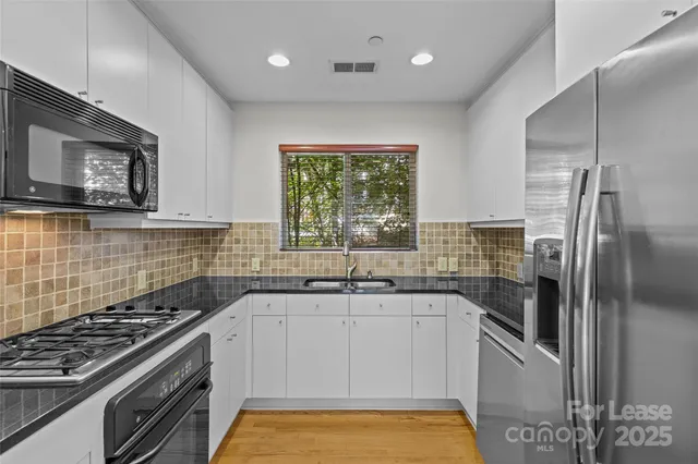 a kitchen with a sink stove and refrigerator