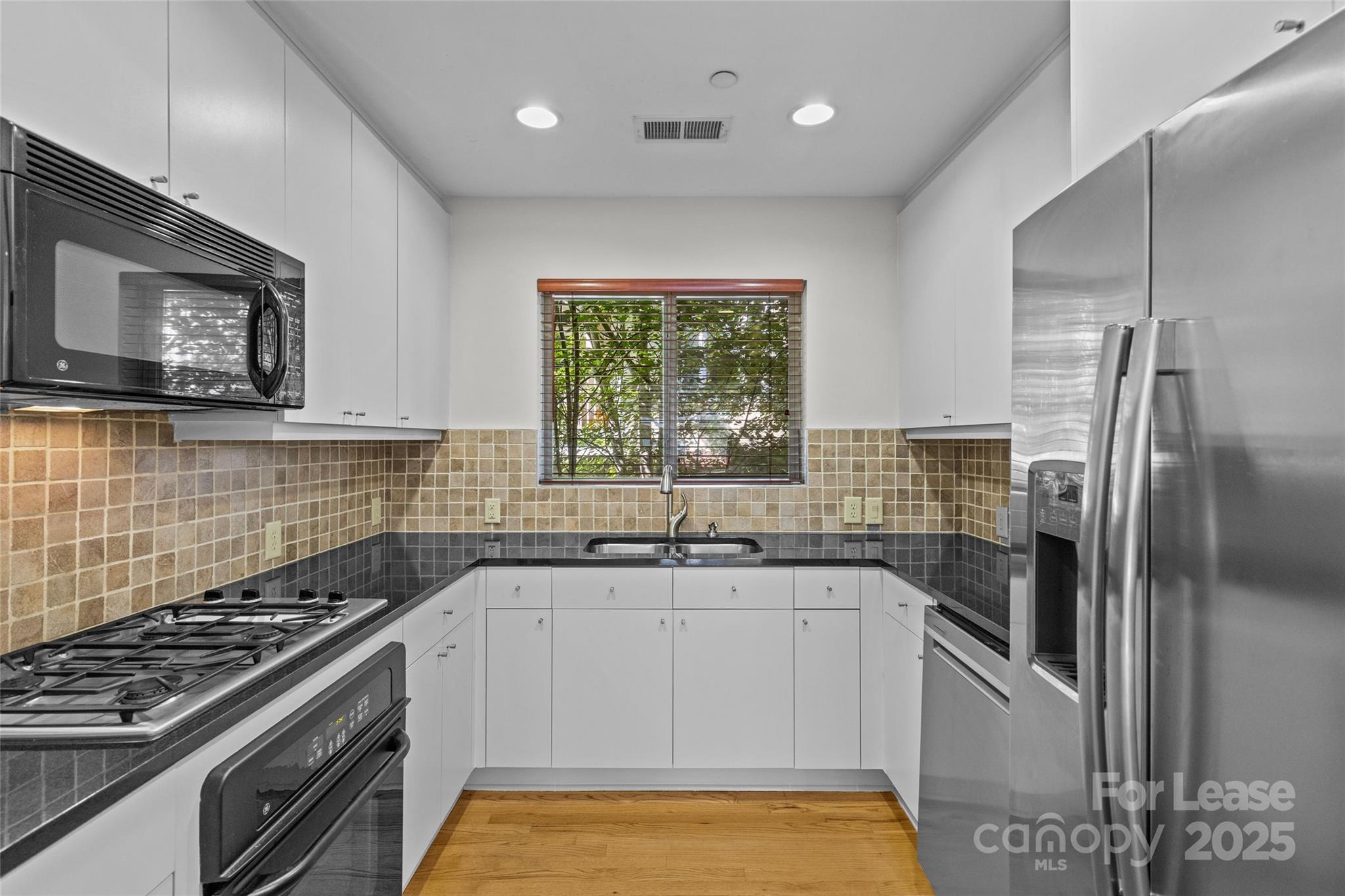 420 Queens Road, Unit 7 Charlotte, NC 28207 - Photo 35 of 46 a kitchen with a sink stove and refrigerator
