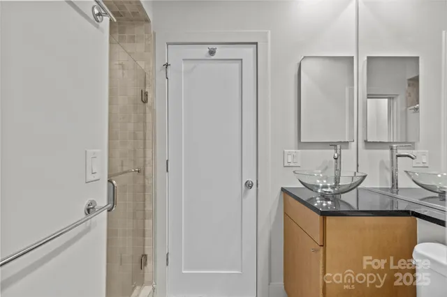 a bathroom with double vanity and a mirror