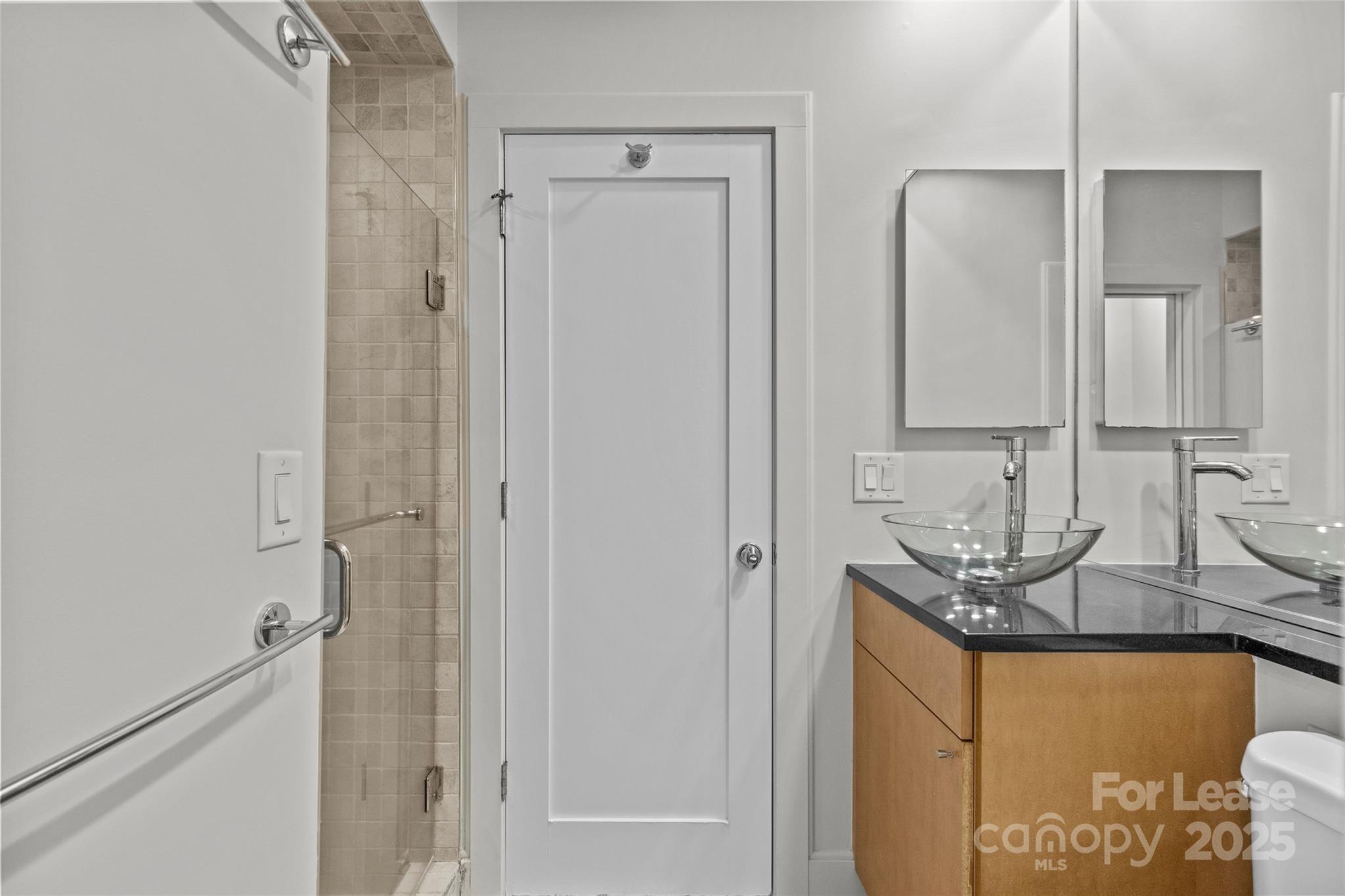 420 Queens Road, Unit 7 Charlotte, NC 28207 - Photo 44 of 46 a bathroom with double vanity and a mirror