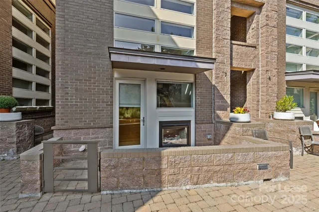 front view of a brick house with a small yard