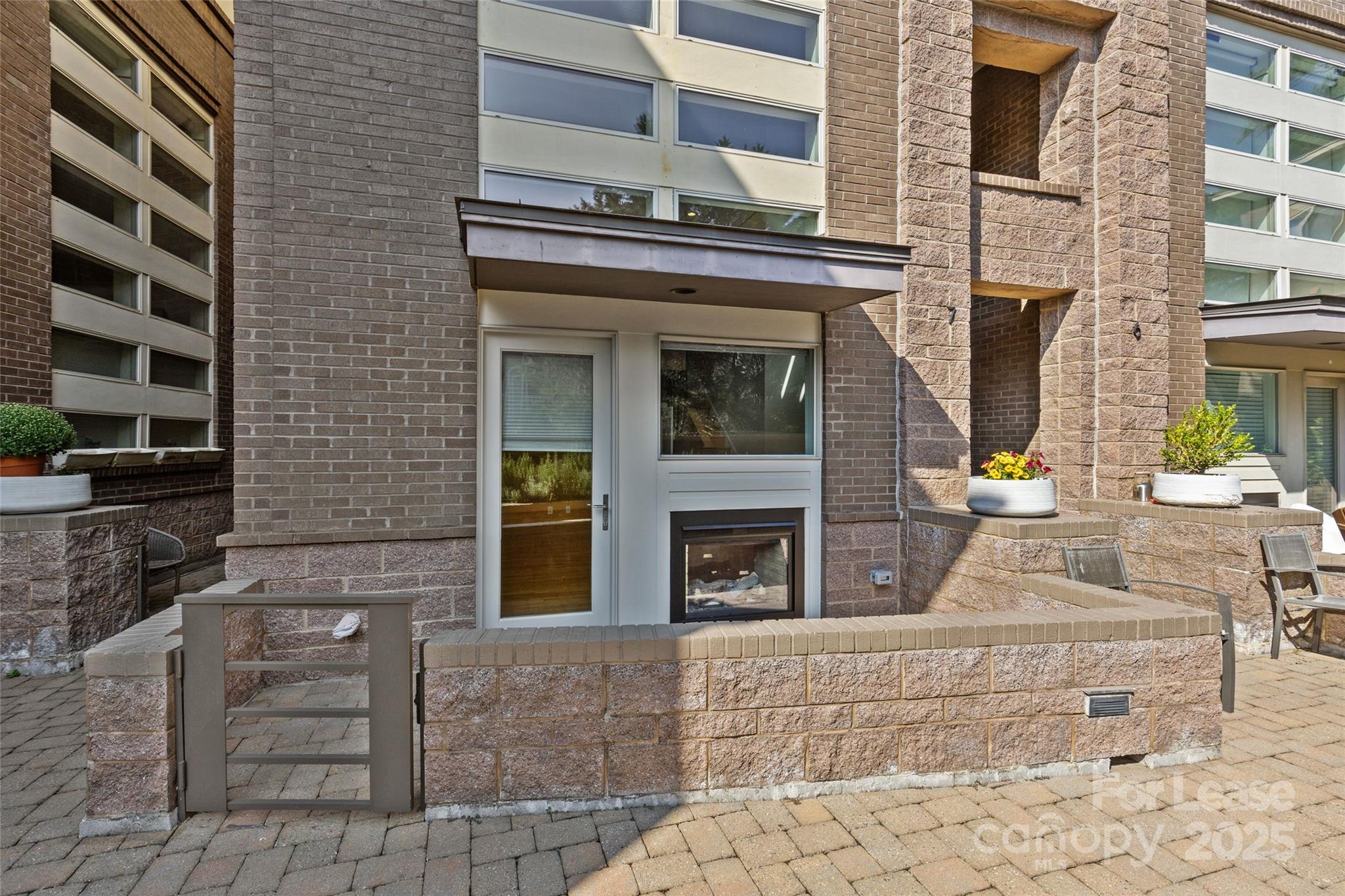 420 Queens Road, Unit 7 Charlotte, NC 28207 - Photo 9 of 46 front view of a brick house with a small yard