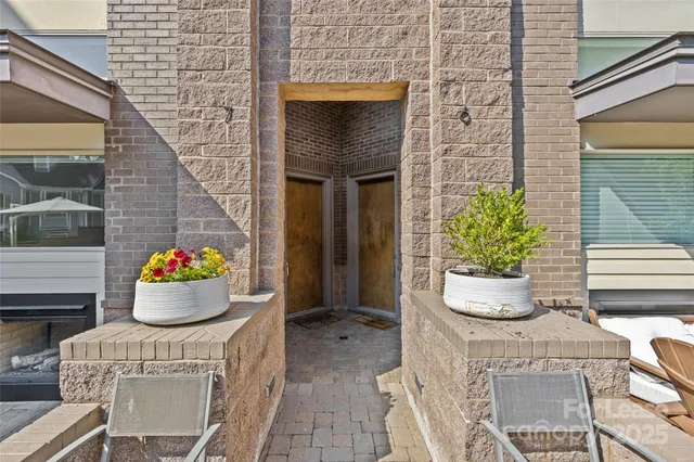 a front view of a house with a potted plant