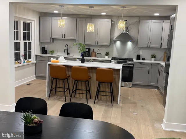 a kitchen with a table chairs sink and cabinets