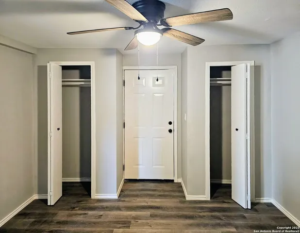 a view of a livingroom with wooden floor and a ceiling fan