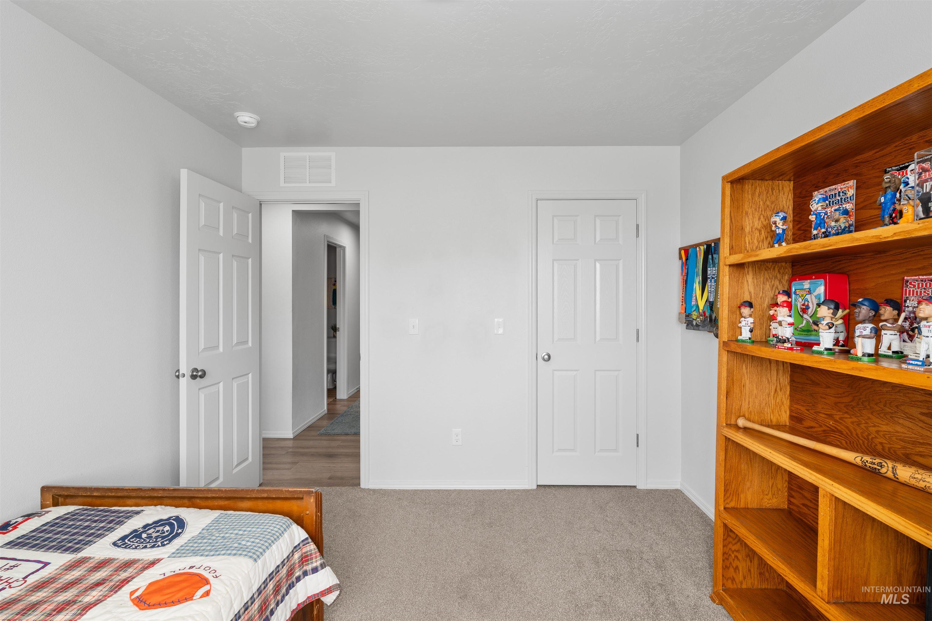 12731 Sondra Street Caldwell, ID 83607 - Photo 15 of 46 Bedroom with light carpet and baseboards
