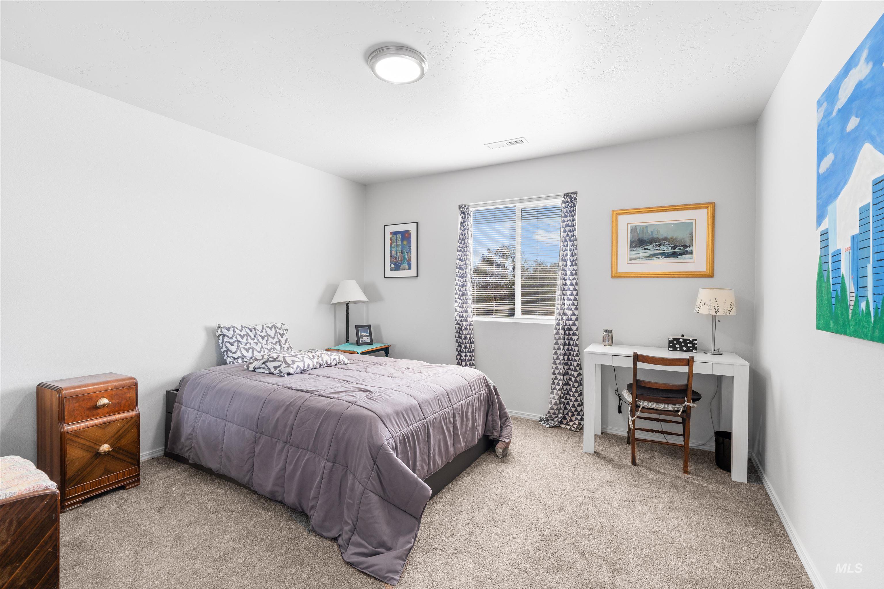 12731 Sondra Street Caldwell, ID 83607 - Photo 26 of 46 Bedroom featuring light colored carpet and a desk
