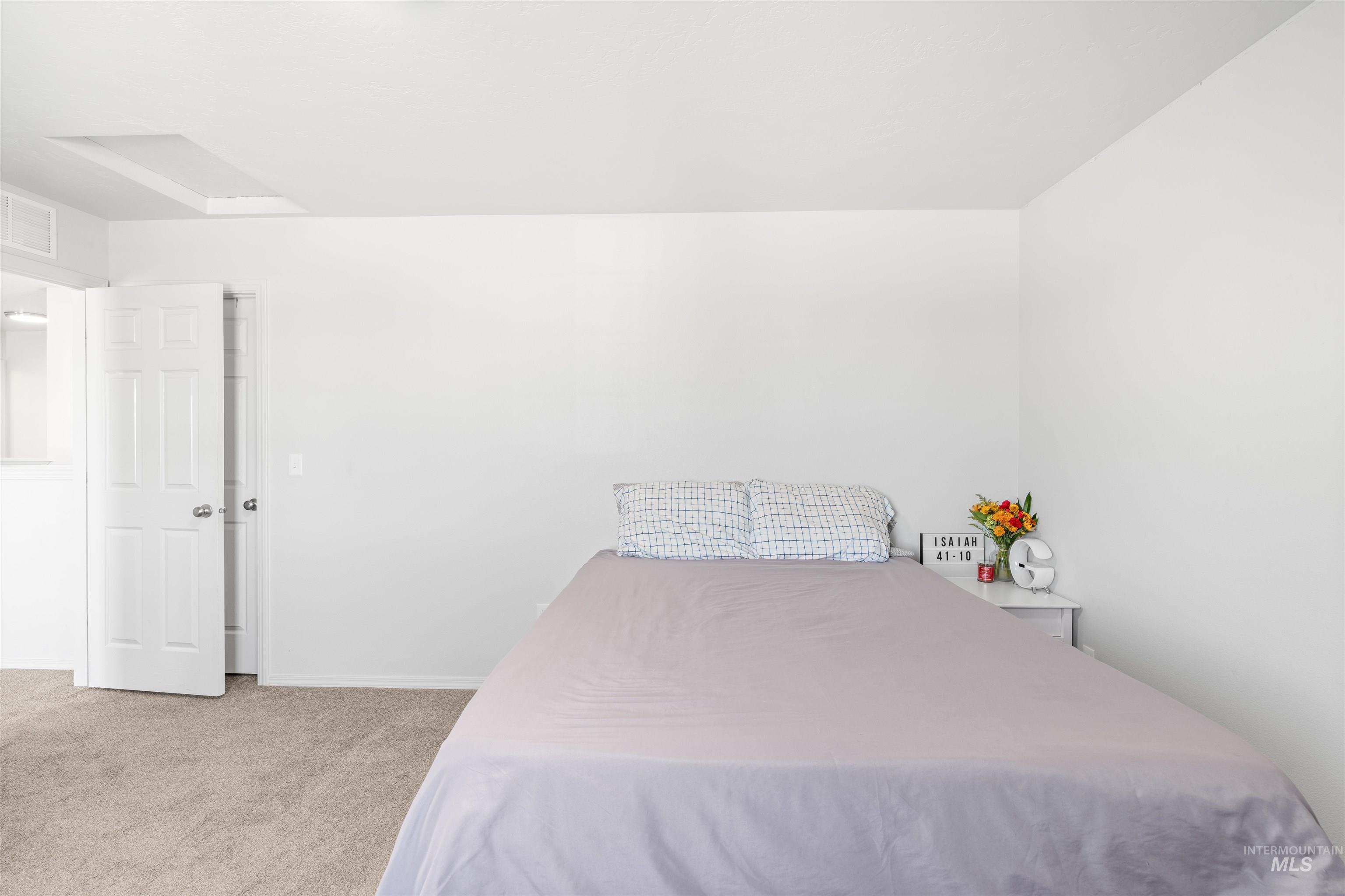 12731 Sondra Street Caldwell, ID 83607 - Photo 36 of 46 Bedroom with light colored carpet and attic access