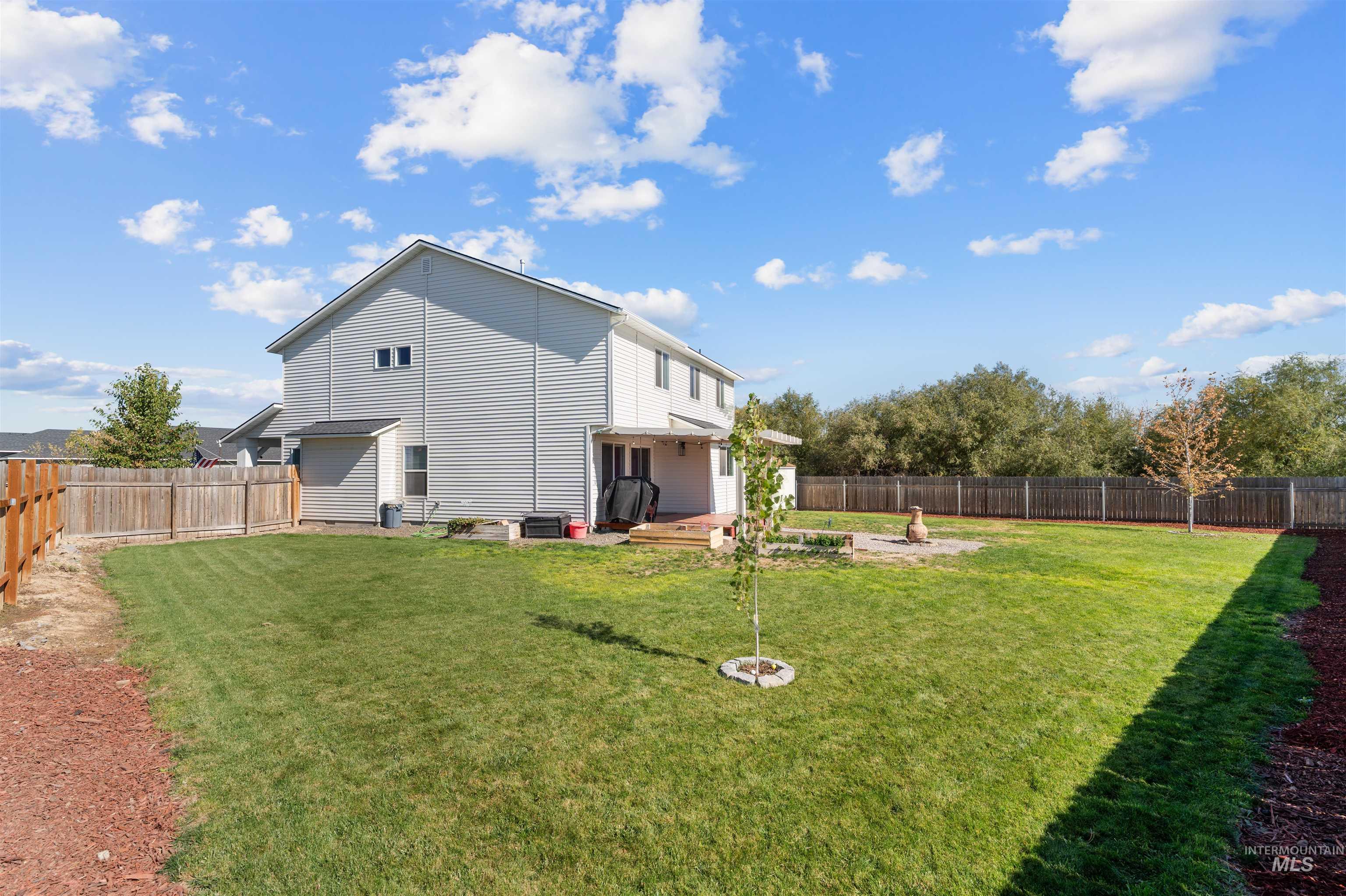 12731 Sondra Street Caldwell, ID 83607 - Photo 4 of 46 Back of property with a fenced backyard and a wooden deck