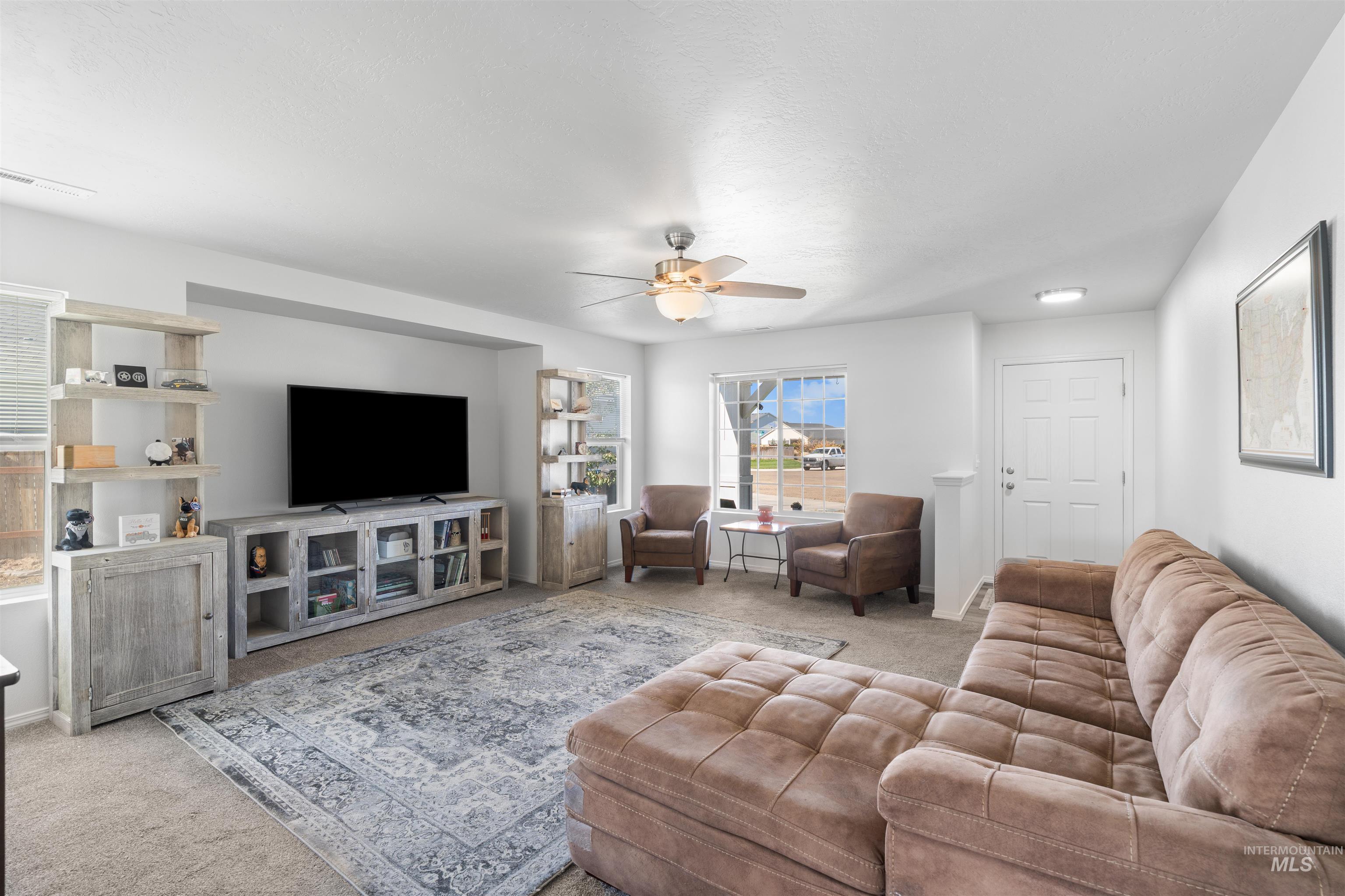 12731 Sondra Street Caldwell, ID 83607 - Photo 6 of 46 Living room featuring carpet floors and a ceiling fan