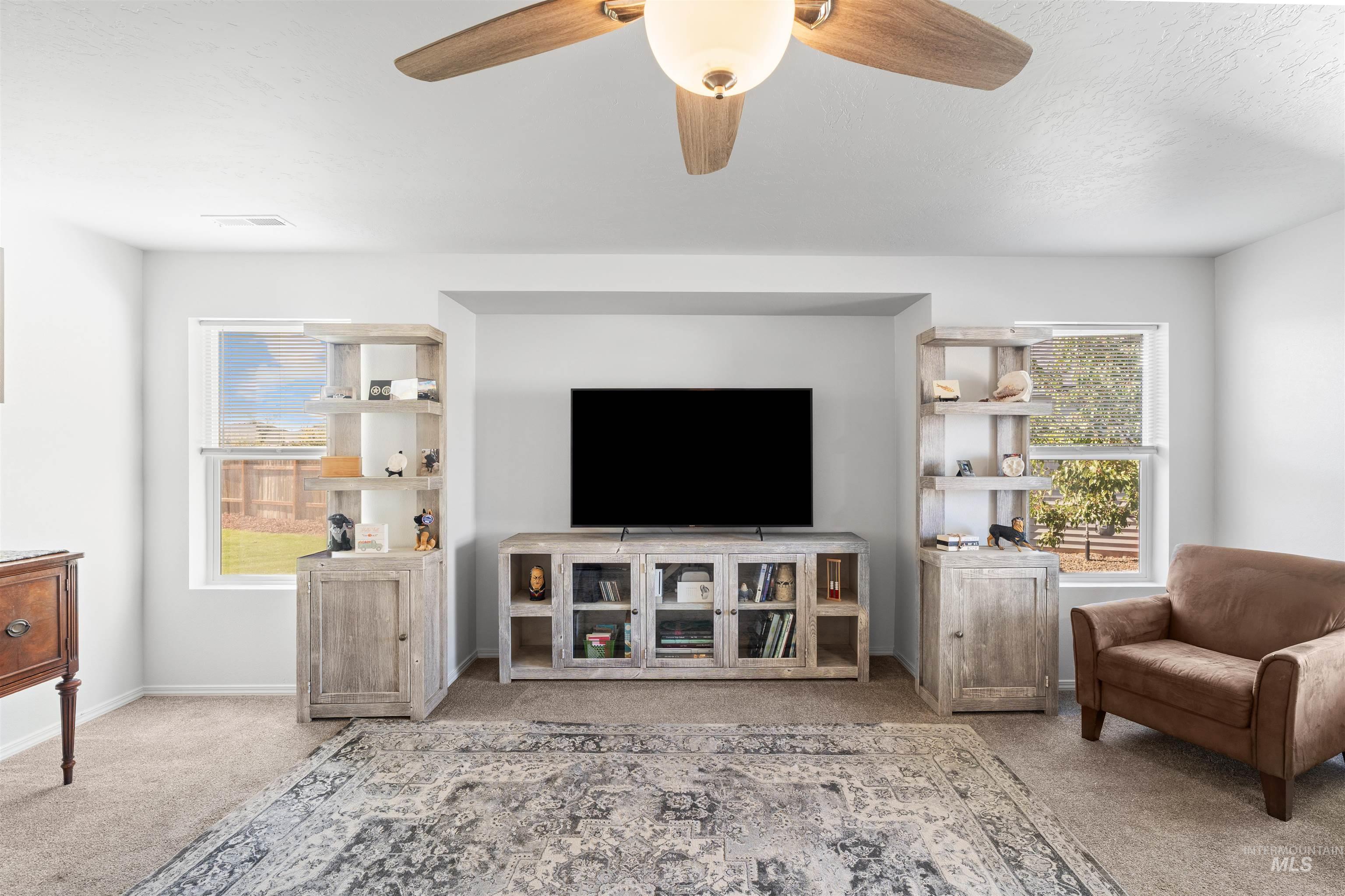 12731 Sondra Street Caldwell, ID 83607 - Photo 8 of 46 Living room with carpet floors, a ceiling fan, and a textured ceiling