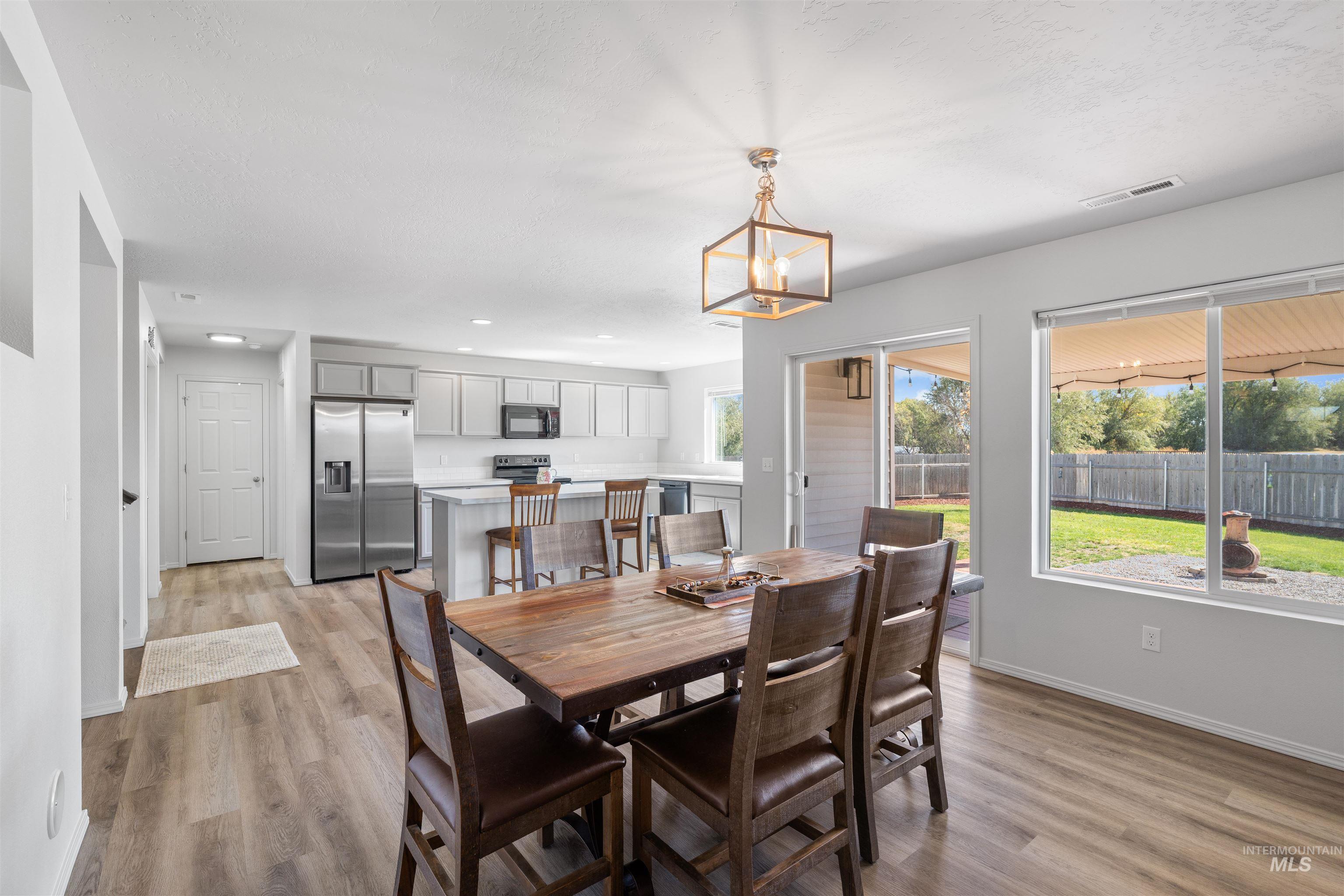 12731 Sondra Street Caldwell, ID 83607 - Photo 9 of 46 Dining space with light wood-style floors, a chandelier, and recessed lighting
