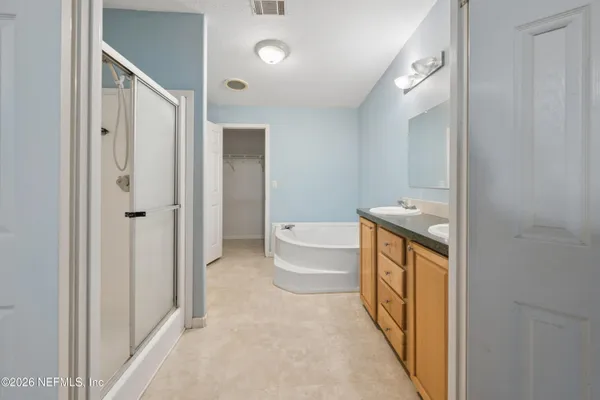 a spacious bathroom with a bathtub shower sink and toilet