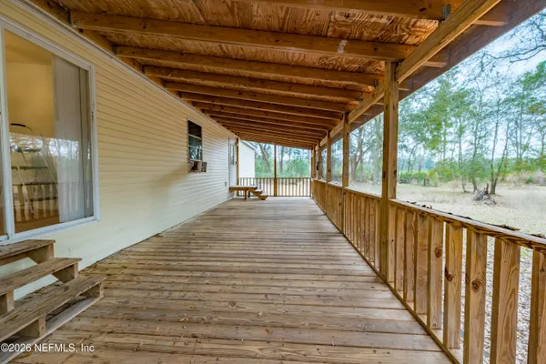 a view of balcony with wooden floor
