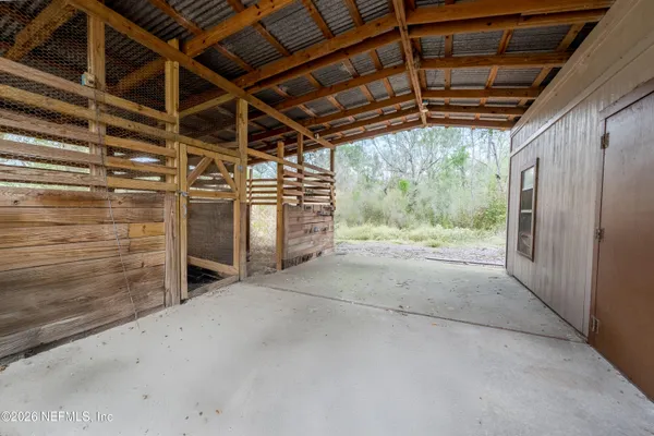 a view of empty room with wooden walls