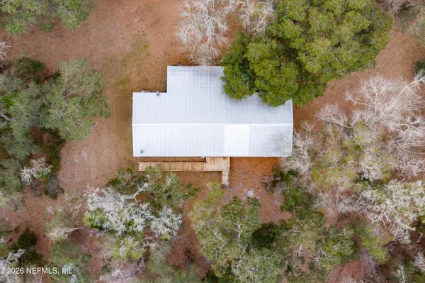an aerial view of house with yard