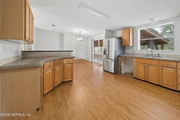 a kitchen with a sink cabinets stainless steel appliances and a window