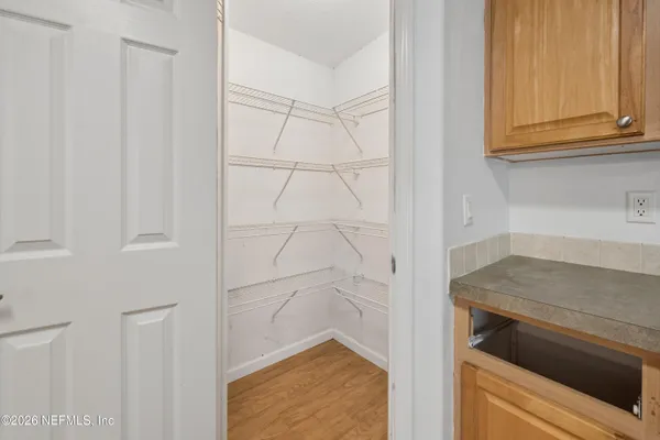 a utility room with granite countertop cabinets washer and dryer