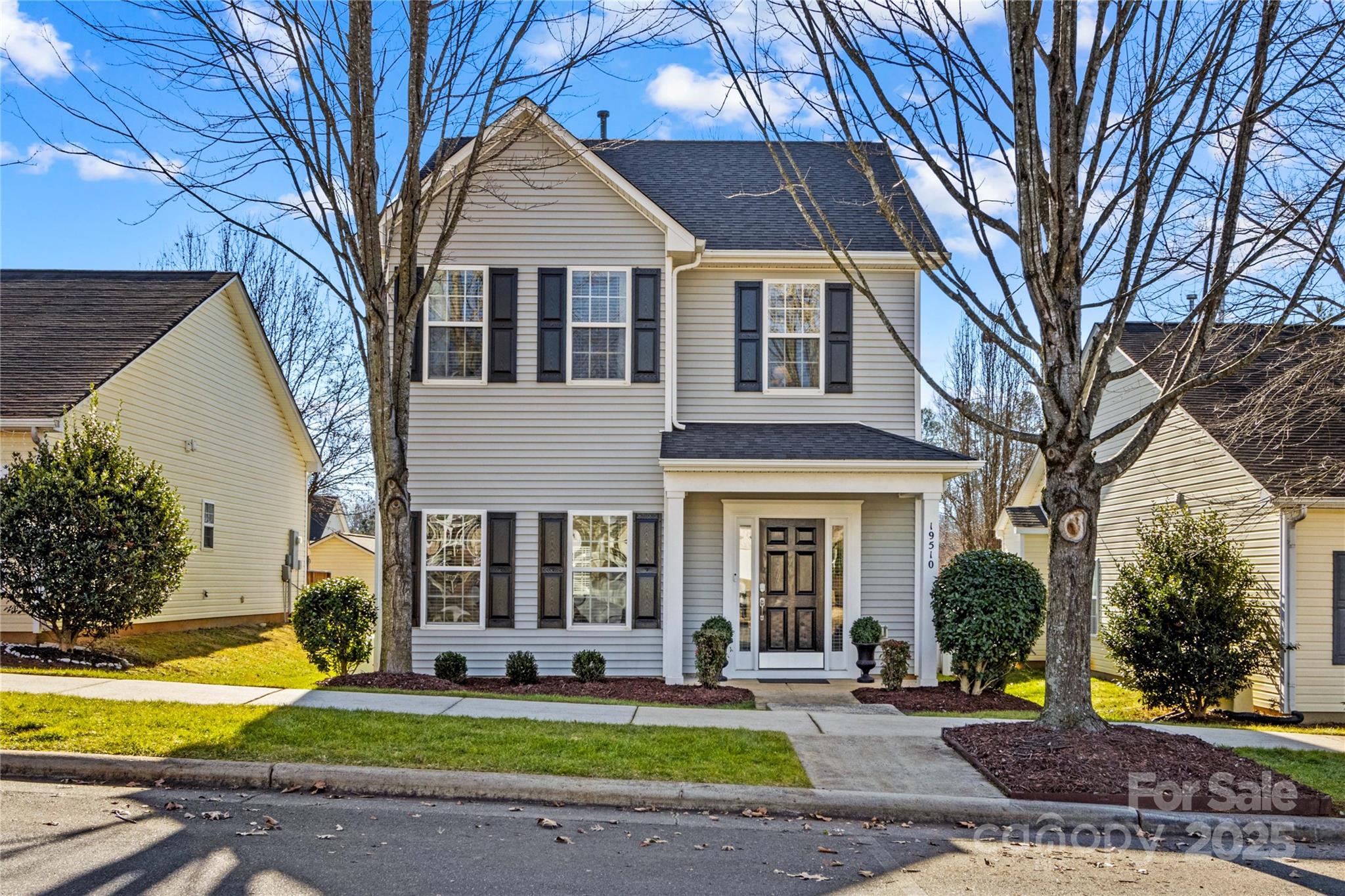 19510 Deer Valley Drive Cornelius, NC 28031 - Photo 2 of 48 a front view of a house with a yard table and chairs