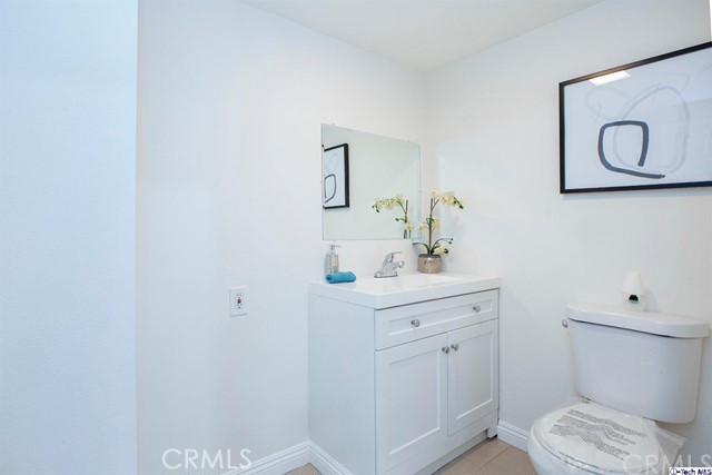 1523 East Windsor Road, Unit 209A Glendale, CA 91205 - Photo 12 of 29 a bathroom with a toilet a sink and mirror