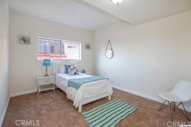 1523 East Windsor Road, Unit 209A Glendale, CA 91205 - Photo 15 of 29 a bed room with a bed and a chair