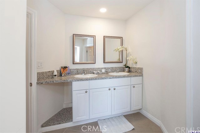 1523 East Windsor Road, Unit 209A Glendale, CA 91205 - Photo 18 of 29 a bathroom with a granite countertop sink and a mirror