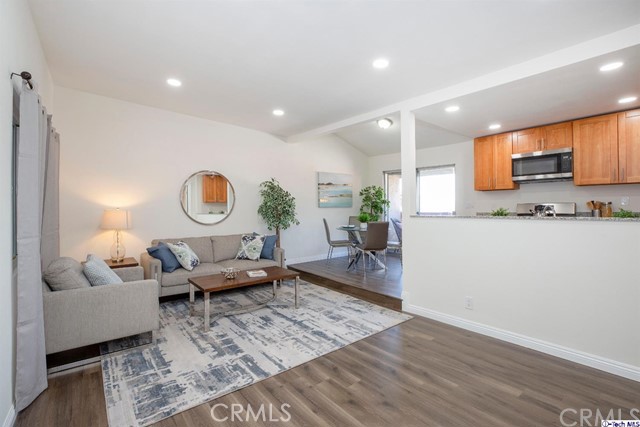 1523 East Windsor Road, Unit 209A Glendale, CA 91205 - Photo 3 of 29 a living room with furniture kitchen view and a wooden floor