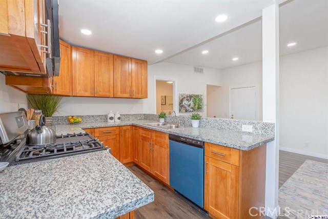 1523 East Windsor Road, Unit 209A Glendale, CA 91205 - Photo 8 of 29 a kitchen with stainless steel appliances granite countertop a sink stove and cabinets