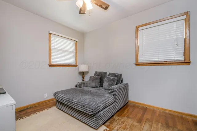 a backyard of a house with a swing and plants