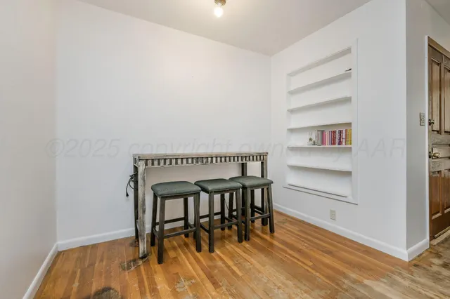 a dining room with furniture and wooden floor