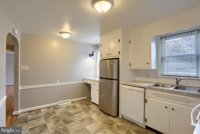 a kitchen with a refrigerator and a sink