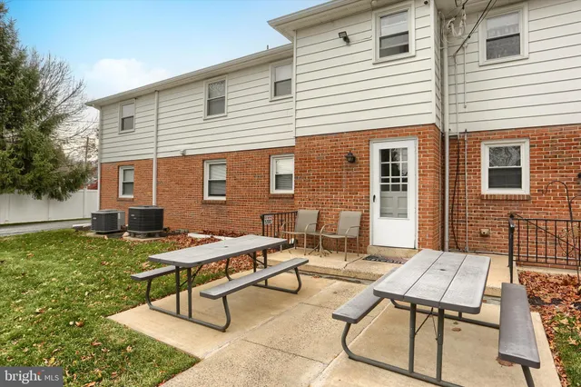 a view of a house with backyard sitting area