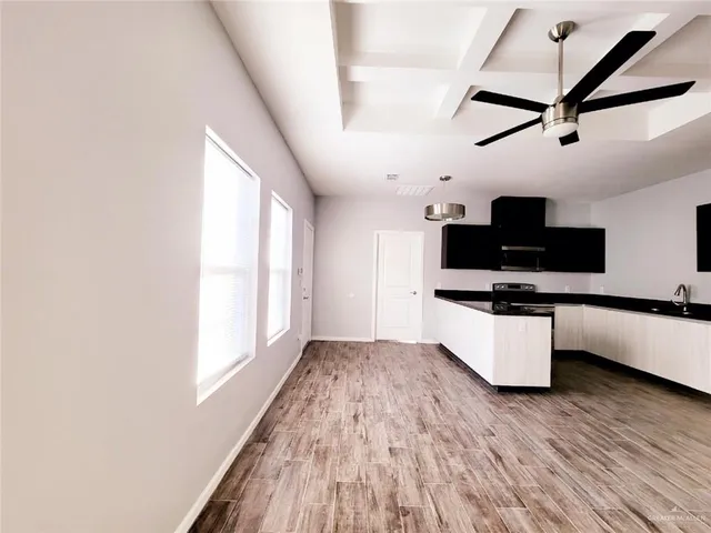 a view of kitchen with sink and wooden floor