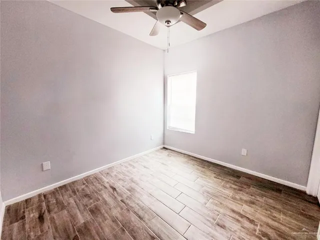 a view of a kitchen with a sink and dishwasher with wooden floor