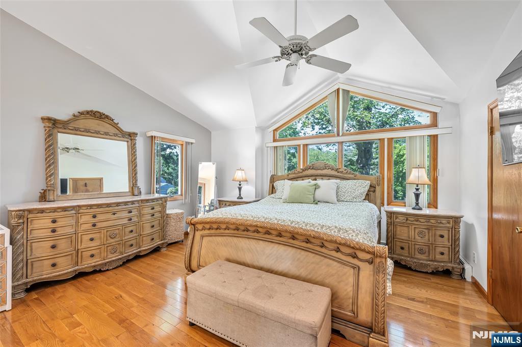 21 Marcia Road Ringwood, NJ 07456 - Photo 15 of 42 a bedroom with a bed a chandelier and dresser