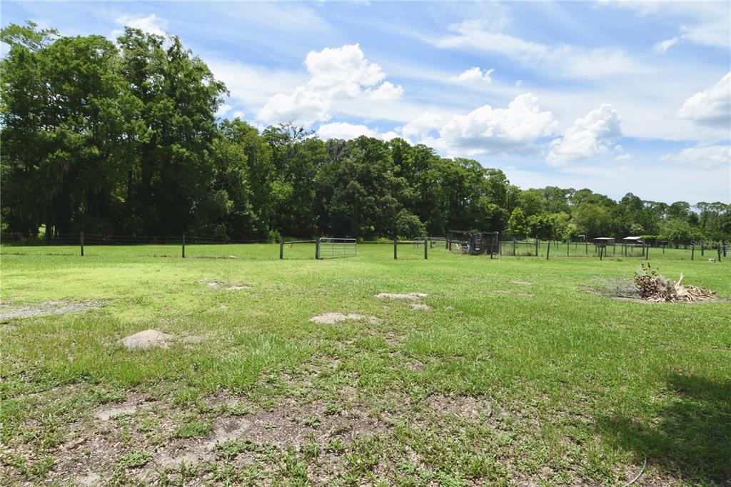 1508 Lake Mills Road Chuluota, FL 32766 - Photo 21 of 37 a view of a green field with wooden fence