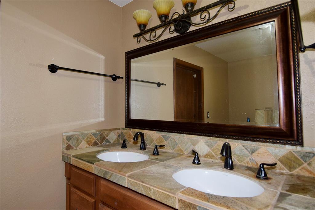 1508 Lake Mills Road Chuluota, FL 32766 - Photo 37 of 37 a bathroom with a granite countertop sink and a mirror