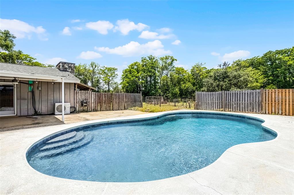 1508 Lake Mills Road Chuluota, FL 32766 - Photo 7 of 37 a view of a backyard with swimming pool and deck