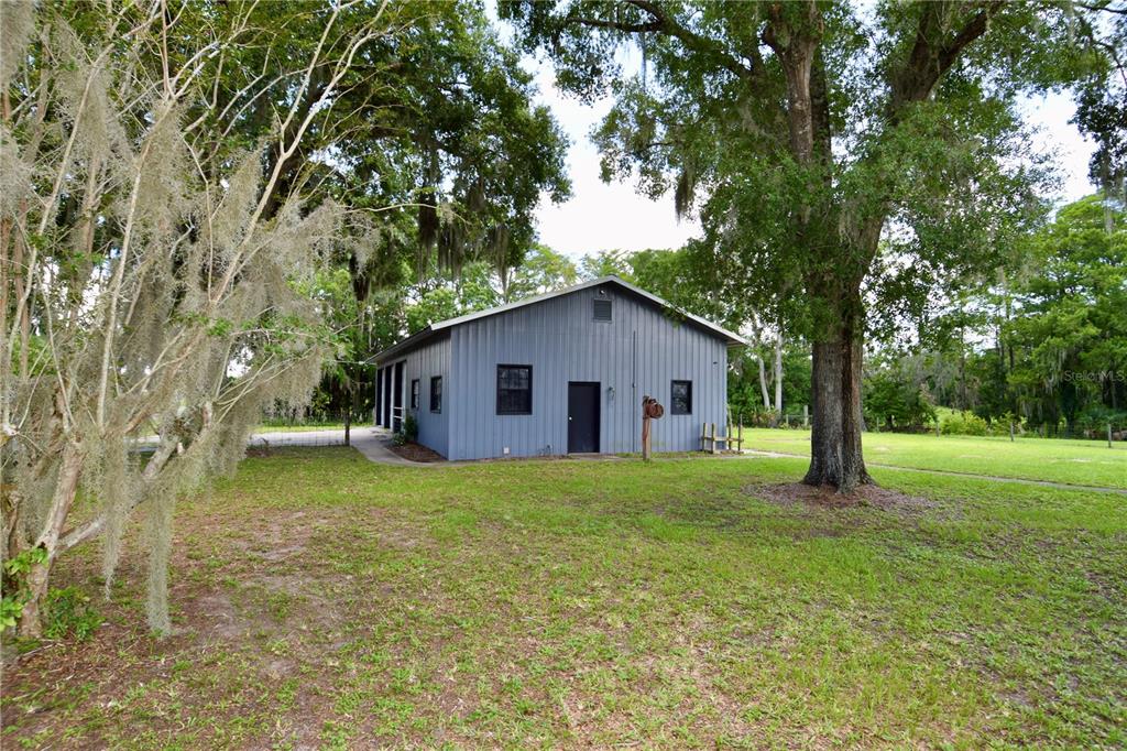 1508 Lake Mills Road Chuluota, FL 32766 - Photo 8 of 37 a yellow house in middle of the forest