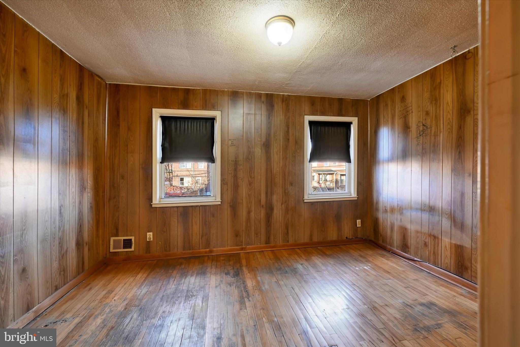414 Kane Street Baltimore, MD 21224 - Photo 13 of 15 a view of an empty room with wooden floor and a window