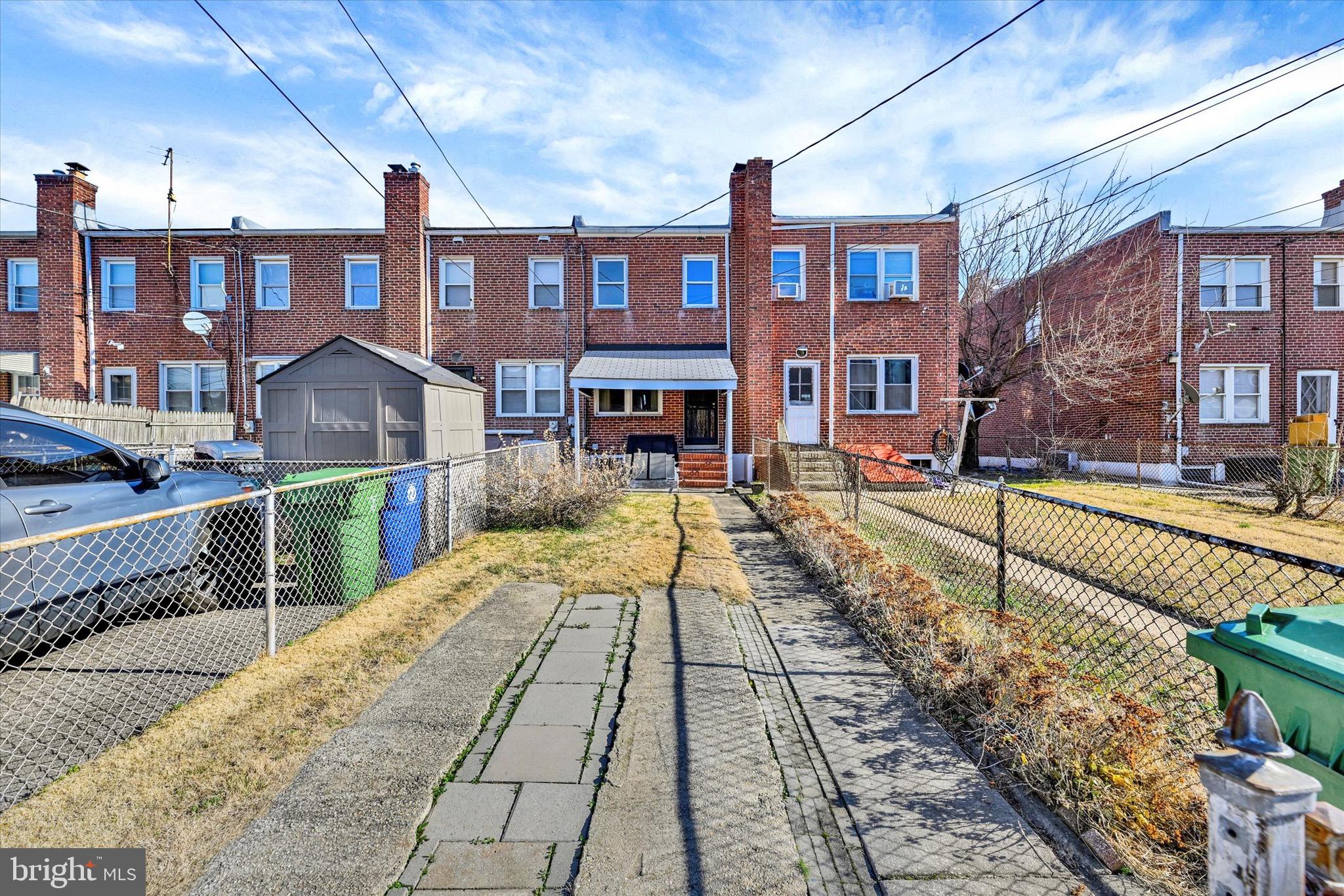 414 Kane Street Baltimore, MD 21224 - Photo 15 of 15 a view of a brick building next to a yard