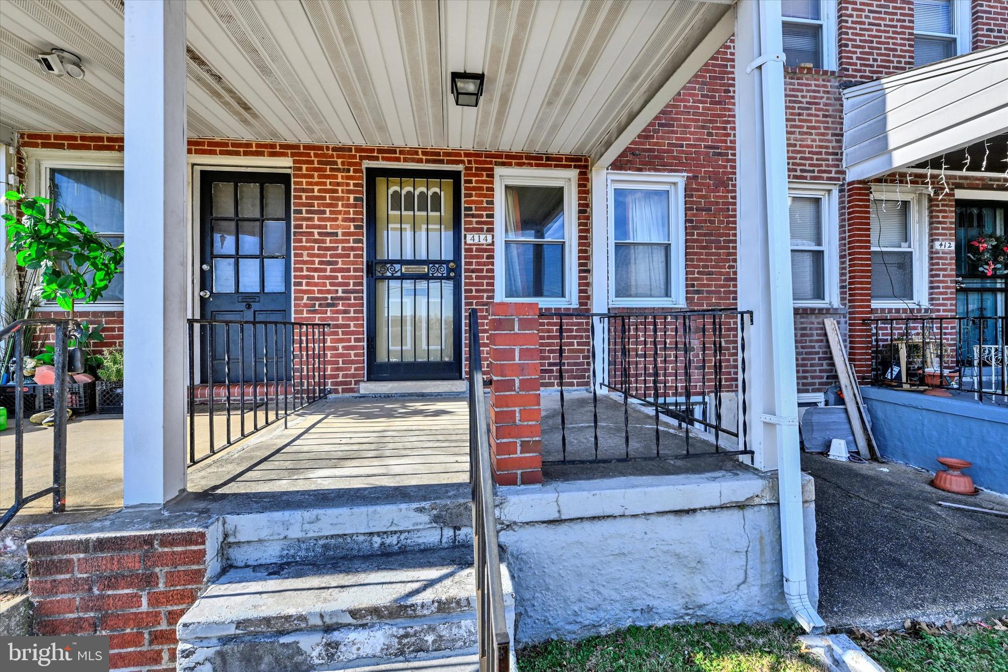 414 Kane Street Baltimore, MD 21224 - Photo 3 of 15 a front view of a house with a porch